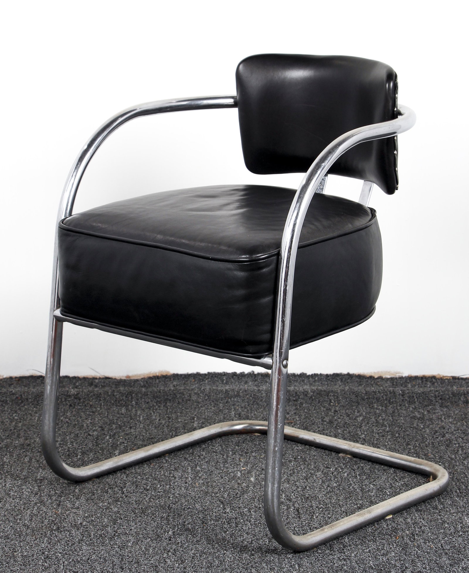 Tubular Club Chair with black leather upholstery: Art Deco Style Tubular Club Chair with black leather upholostery by Gene Sanes, 31 x 20.5 x 22 inches.
