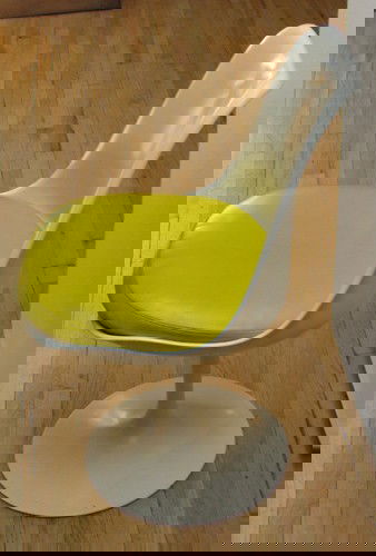 Eero Saarinen Tulip Chair with yellow seat: Artist: Saarinen, Eero for Knoll Title: Tulip Chair Medium: polycoated metal Dimensions: 32 x 19 x 19 inches Signature: Knoll International label underseat