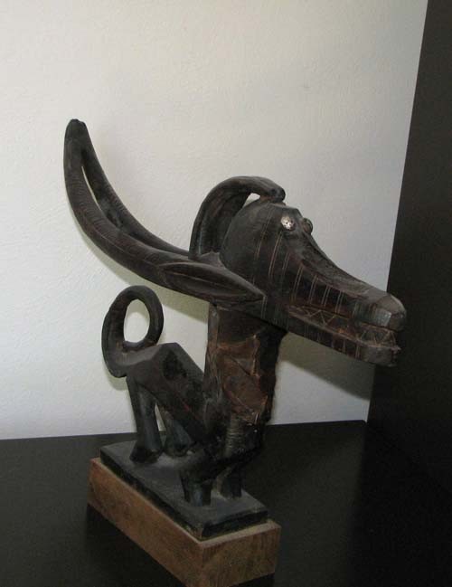 Chi Wara Antelope Sculpture with Monkey Skin Neck: Artist: Niger Region/ Mali Title: Horizontal Chi Wara Antelope Sculpture with Monkey Skin Neck Medium: carved wood, metal tacks and monkey skin Dimensions: 11.5 x 18.5 x 3 inches Provenance: Tribal Ar