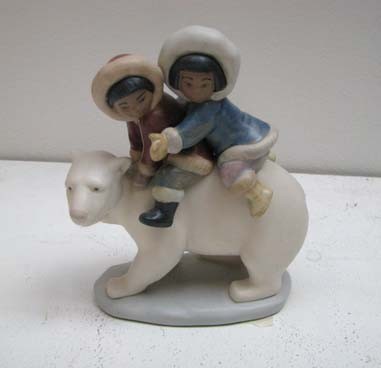 Lladro Alaskan children and polar bear figurine: Artist: Lladro Title: Inuit Children Riding Polar Bear Date: 1985 Medium: Porcelain Dimensions: 7 1/2 x 5 1/4 x 2 3/4 inches Edition Number: 2270 Description: Handmade in Spain