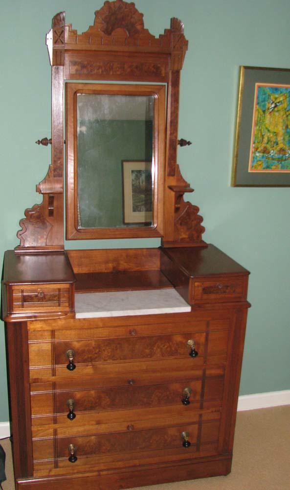 East Lake Victorian Marble Top Dressing Table with: East Lake Victorian Marble Top Dressing Table with free moving Mirror with arched crown finnial, 2 small drawers over 3 large drawers, hanging ball handles Medium: burled walnut with marble top Dimens