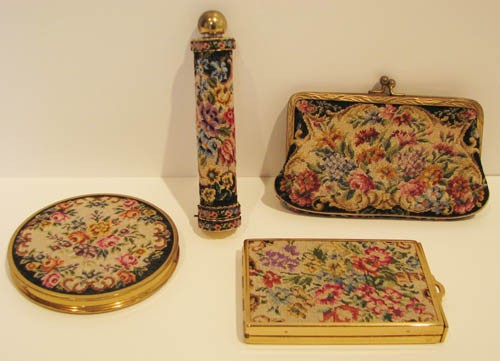 Needlepoint Covered Compact Set: Needlepoint Covered Compact Set including lipstick case, round powder, mirror, coin purse Medium: needlepoint Dimensions: compact: 3 inch diameter Signature: stamped "Made in America" on mirror