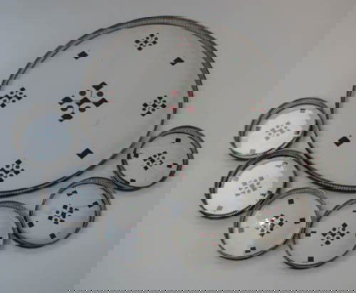 Silver's Brooklyn Art Deco pattern tray and coaste: Artist: Silver's Brooklyn Title: Silver's Brooklyn Art Deco pattern tray with 6 coasters, each with pierced silverplate rims Medium: ceramic with silverplate border Dimensions: tray 12 inches in diame