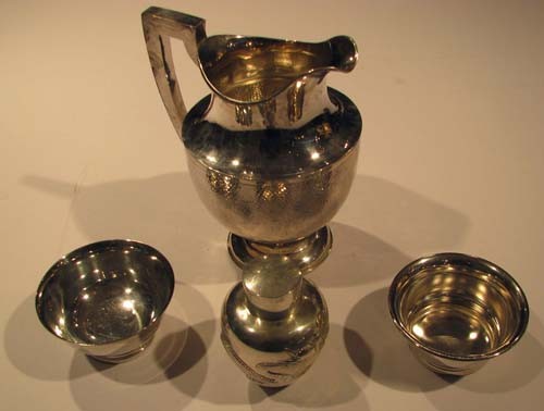 Chinese Silver Pitcher (Sing Fat) with Shaker and : Chinese Silver Pitcher with hammered decoration (marked SF 90); Dragon Decorated Silver Shaker (marked 85) and 2 silverplate bowls (Fallstaff and Gorham) Date: c. 1870-1920 Medium: chinese silver Dime