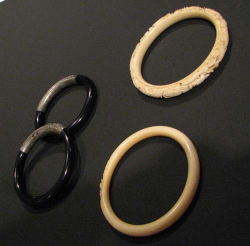 4 Antique Carved Ivory and Wood Bangle Bracelets: 4 Carved Ivory with dragon and lilly designs and Ebonized Wood with engraved Silver Detail Bangle Bracelets Medium: ivory, ebonized wood Dimensions: diameter : 3.25 inches Provenance: Purchased by a T