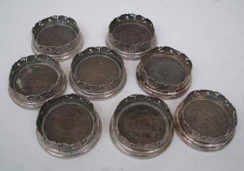 8 Silver plate coasters: Title: 8 Silver plate coasters (plate worn) Medium: silverplate Dimension: 1 x 3.25 x 3.25 inches Provenance:The Estate of Emily F. Oliver, Sewickley, PA