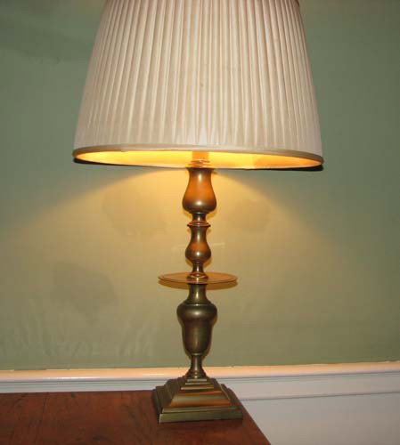 Pair of brass candlestick lamps: Title: Pair of brass candlestick lamps with fabric shades Medium: brass Dimension: 31 inches with shade Provenance:The Estate of Emily F. Oliver, Sewickley, PA