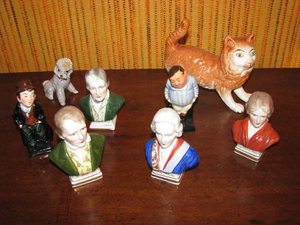 Lot of ceramic figurines including Royal Doulton: Title: Lot of ceramic figurines comprising: cat, dog, four bust figurines and two Royal Doulton Dickens figures Medium: ceramic Dimension: cat measures: 5 x 6.5 x 2.25 inches Provenance:The Estate of