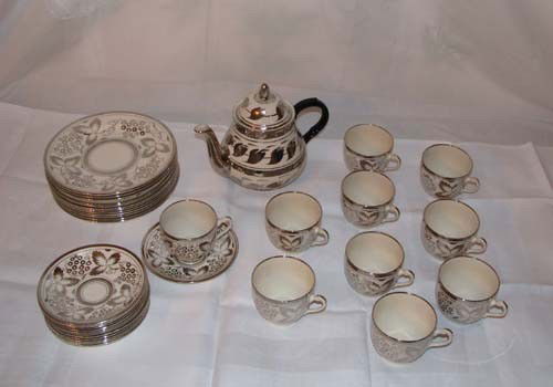 Silver and white lustre tea set: Title: Silver and white lustre tea set comprising: 12 tea plates, 12 saucers, 10 tea cups, 1 teapot Medium: lustreware Provenance:The Estate of Emily F. Oliver, Sewickley, PA
