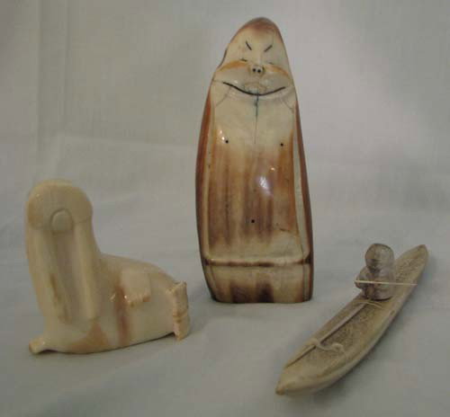 3 Collection of Eskimo sculptures: Title: Collection of Eskimo sculptures: walrus tusk in kayak; Eskimo with small whale; and tusk of walrus Medium: bone Dimension: tusk: 5.75 inches tall Provenance:The Estate of Emily F. Oliver, Sewic