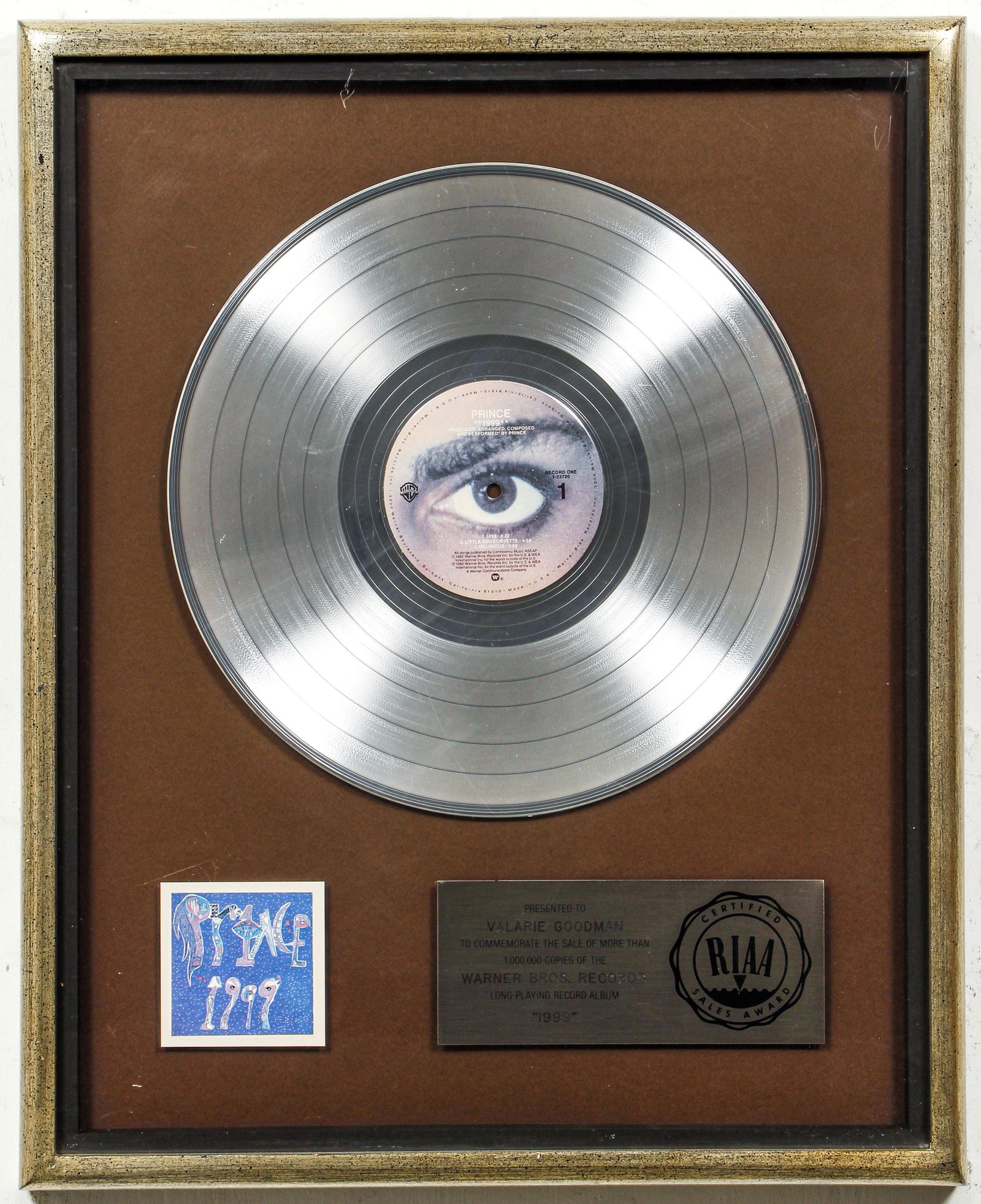 Prince 1999 Platinum Record Plaque for Promotions Exec: Prince Platinum Record plaque for his 1982 album titled 1999, certified sales award from the RIAA, presented to a Warner Brothers Records Promotions executive, in a frame 20.5 x 17 inches. Provenance: