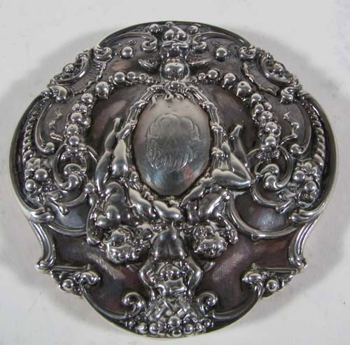 Tiffany Sterling Pill Box: Artist: Tiffany Title: Tiffany Sterling Pill Box with Baroque style "Putti and Vine" embellishment, with gold wash interior Medium: Sterling Dimensions: 1.89 ozt Signature: stamped Tiffany on undersi