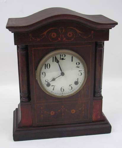 An Edwardian inlaid mahogany Gilbert Mantel Clock: Artist: William Gilbert Clock Co. Winsted Connecticut Title: An Edwardian inlaid mahogany , break-arch pedimented case with garland and swag decorations and thin line border inlay to front, flanked by
