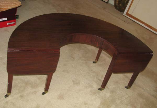 Mahogany Hunt Table with drawer and 2 folding legs: Title: Mahogany Hunt Table with drawer and two folding leaves on brass casters Medium: mahogany Dimensions: 22.5 x 36 x 54 inches Provenance: Dr. Mervin Binstock