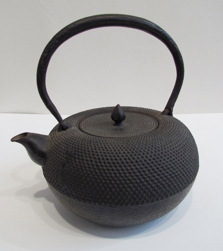 Japanese Iron Tea Kettle: Title: Japanese Iron Tea Kettle, Rice grain pattern body with rustic pattern handle Medium: iron 8.25 x 8.75 x 7 inches