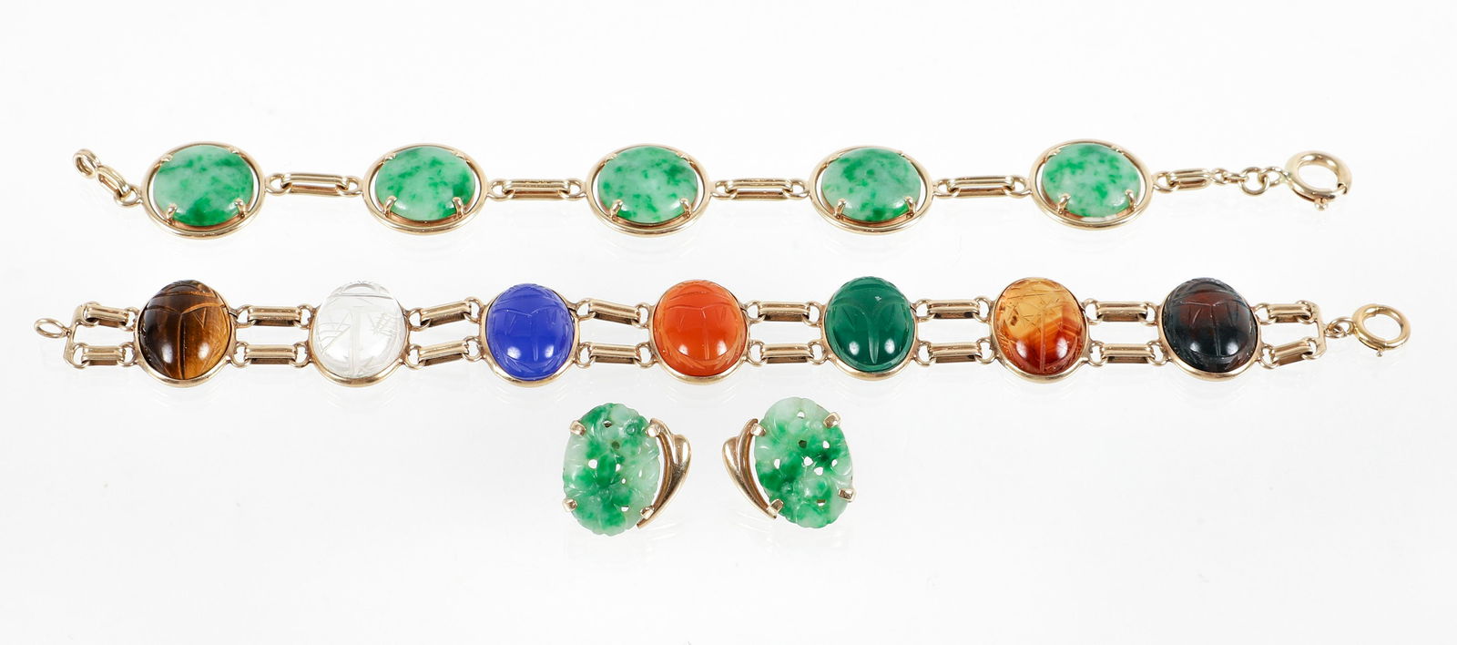 14K Gold Stone Jewelry: 14K gold stone jewelry. Includes 2 cabochon stone, link bracelets and a pair of carved jade earrings. The carved multi stone scarab bracelet is fashioned of 7 assorted stones, each bezel set as a sepa