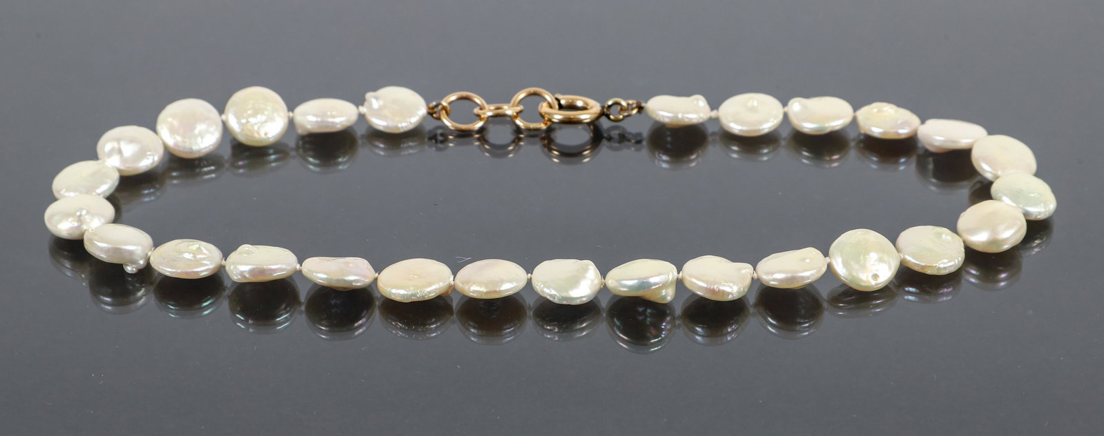 14Kt GF Baroque Pearl Necklace: 14Kt GF baroque pearl necklace. The pearls measure 11.7mm wide and are knotted and finished with a 3 ring extension for 7", 7 1/4", 7 1/2" length.