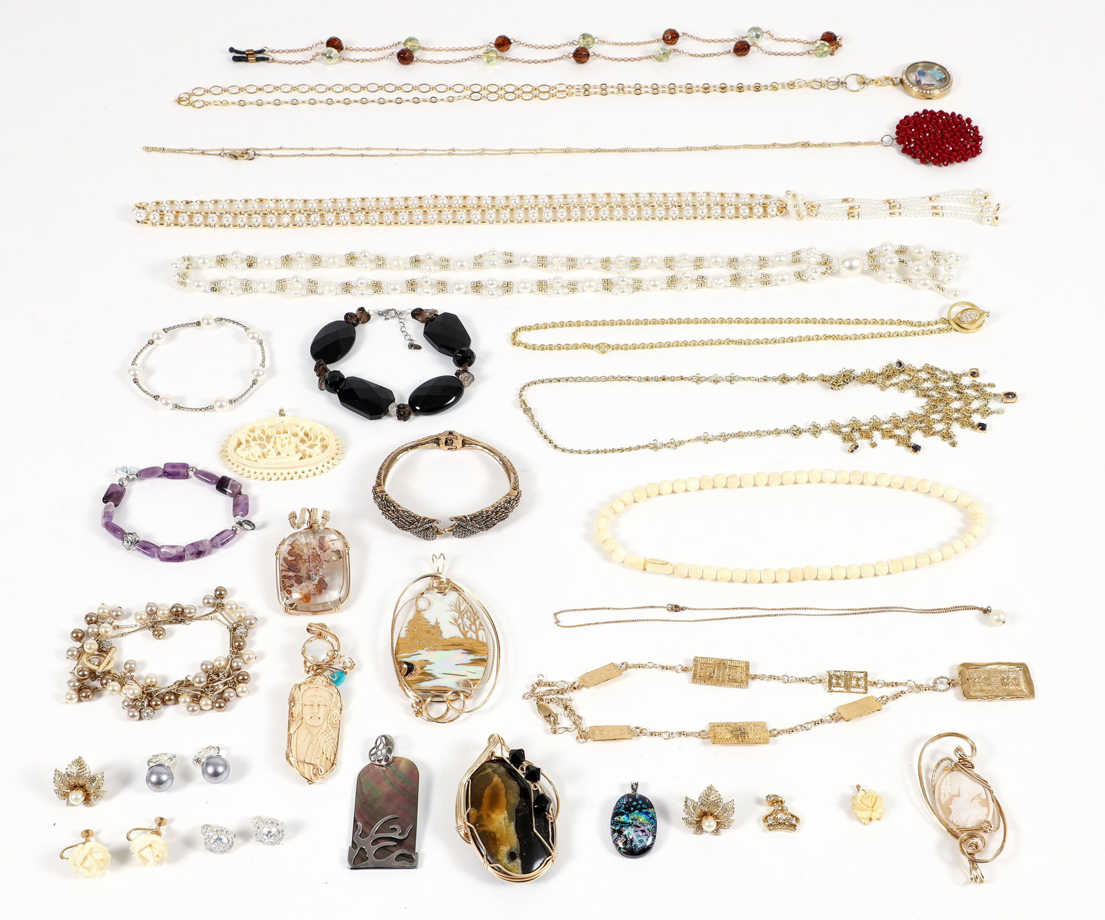 Large lot of Assorted Costume Jewelry: Assorted costume jewelry. Includes 9 pendants, painted porcelain, carved shell and bone. 10 necklaces, gold tone with wrapped stone, pendants, beaded bone, faux pearls. 5 bracelets, carved stone, faux