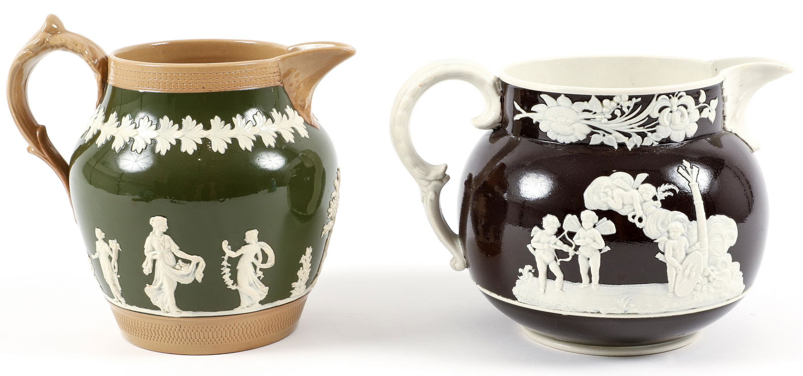 Pair of Wedgwood Pitchers Wilson and Copeland: Pair of wedgwood pitchers in green and brown with Neoclassical figures in white relief, green pitcher stamped Copeland England 12 at bottom, 6.75 inches tall; brown pitcher stamped Wilson at bottom, 5