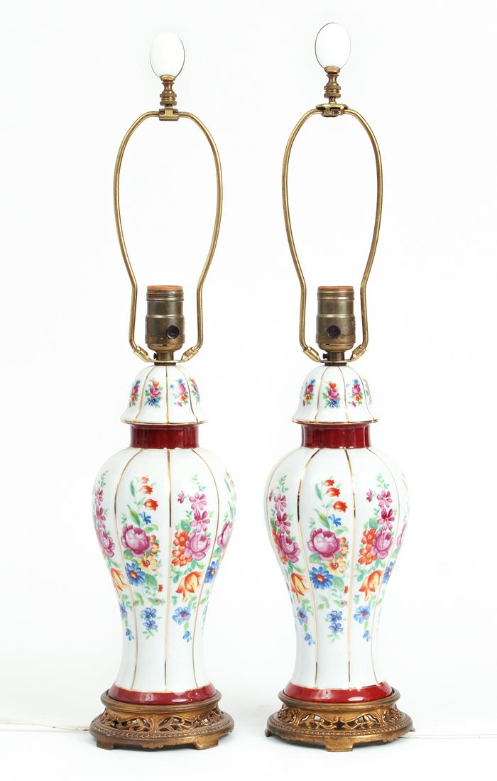 Pair of White Porcelain Lamps: Pair of white porcelain lamps, with floral decoration, base measuring 15 inches, including harp and finial 24 inches.