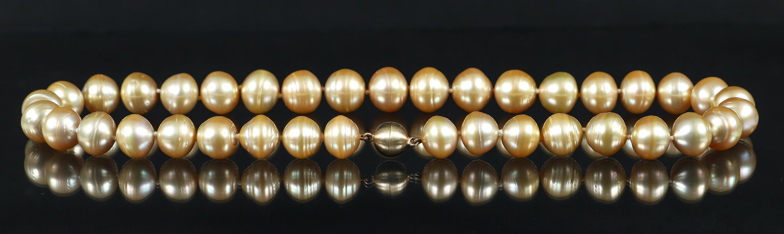 Gold tone Cultured Pearl Necklace: Gold tone cultured pearl necklace. The pearls measure approx. 13.3mm in width. Finished with a magnetic ball clasp. Measure 18" in length.