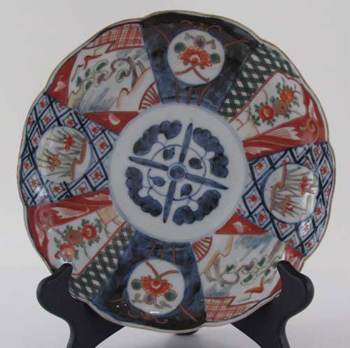 Antique Japanese Imari plate: Title: Antique Japanese Imari plate with scalloped rim and blue pattern on underside Medium: porcelain Dimensions: 8.x 8.5