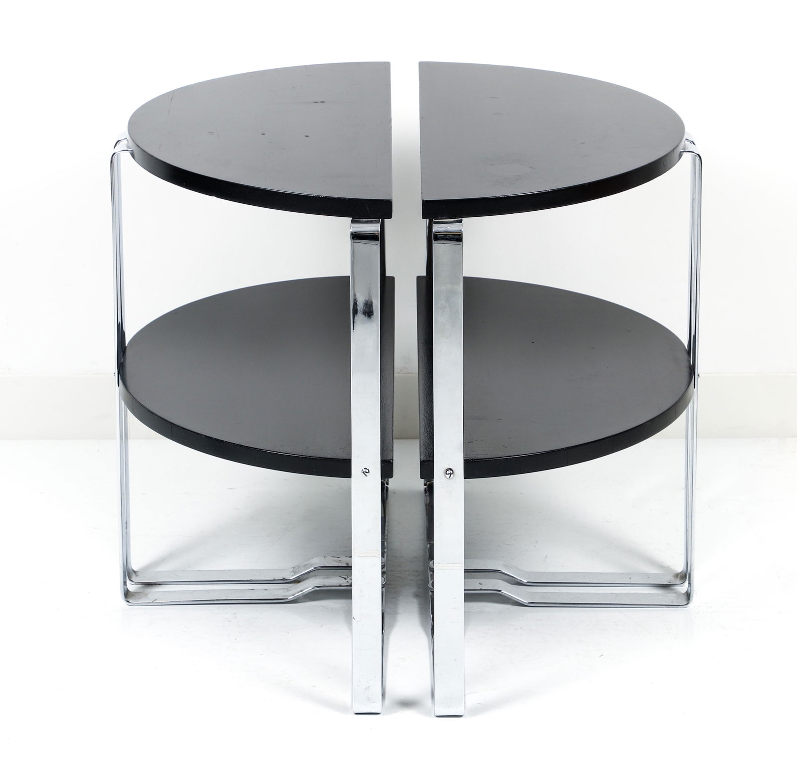 Wolfgang Hoffmann Pair of Demilune Side Tables: Wolfgang Hoffmann for the Howell company, Pair of black lacquer and chromed steel Art Deco demilune side tables, c.1938, model No. 801, measures 22 x 25.5 x 12 inches.