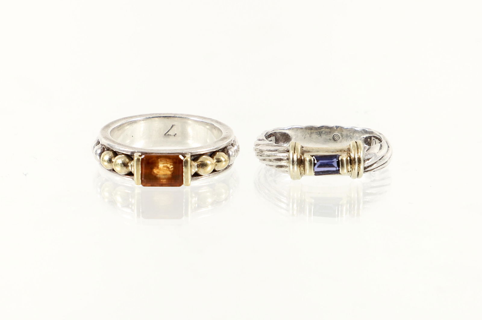 Yurman and Lagos Sterling Gold Rings: David Yurman and Lagos Caviar Sterling and 18K stackable rings. The Yurman cable ring has 14K yellow gold detail and set with a rectangular cut amethyst stone. Measures 4.5 mm in width. Size 7 1/4. Ma