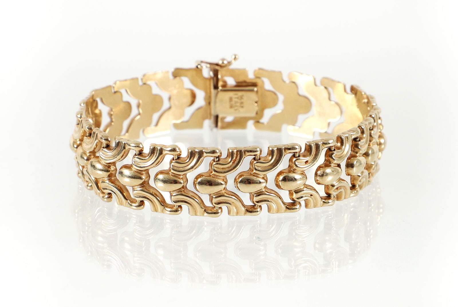 14k Abstract Organic Link Bracelet: 14K yellow gold organic abstract link bracelet. A repeating pattern of curling figures press into pear figures as each polished link of this bracelet. Finished with a hidden box clasp and figure 8 hin