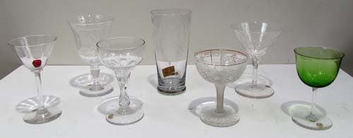 7 Assorted Dorflinger Cordials/Glasses: Title: 7 Assorted Dorflinger Cordials/Glasses including Pilsner Glass with Faces, Cordial with Glass Cherry, Green Glass cordial, other engraved cocktail and cordial glasses Medium: cut glass Dimensio