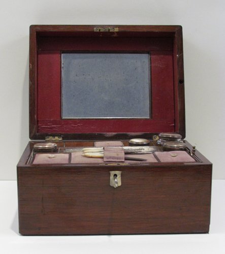 Victorian Vanity Set w Mother of Pearl Handled Too: Title: Victorian Era Traveling Walnut Vanity Set with hidden pull-out side storage drawer, 6 lidded jars, 5 mother of pearl handled manicure set in a lift-out compartment , and 2 shield mother of pear