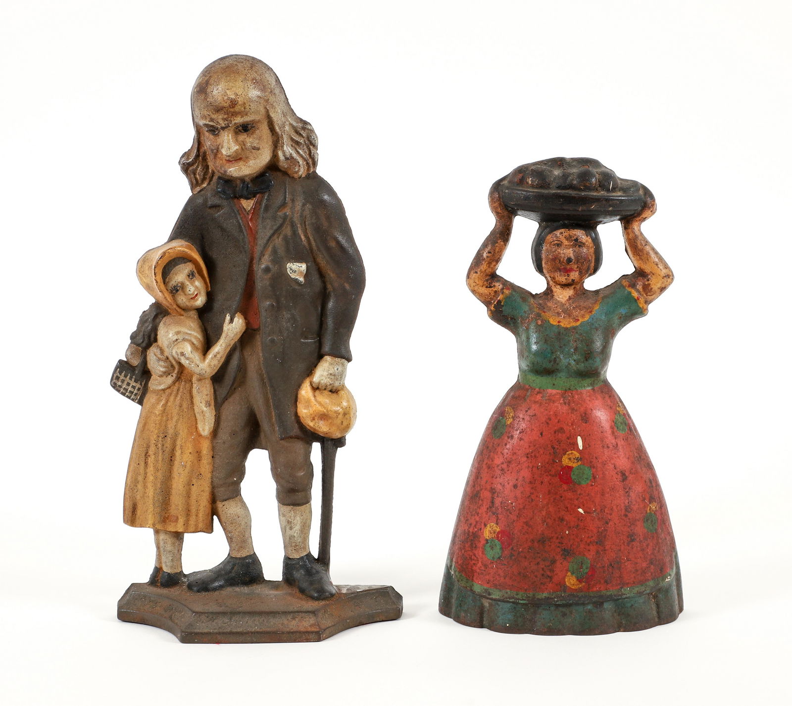 2 Cast Iron Painted Doorstops, Man and Daughter, Woman: Two early 20th century painted cast iron doorstops, including: a woman with a basket of fruit atop her head, apparently unmarked, 11.5 x 6 x 2.25 inches; a man standing with child, apparently unmarked