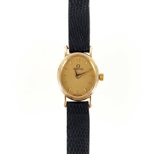 Womens 14K Omega Wristwatch: Womens 14K yellow gold Omega quartz Swiss wristwatch with brown lizard band. The mechanical watch is oval in shape 3/4" in length, 3/4" wide including stem. The case is marked "585 Quartz 1455". The c