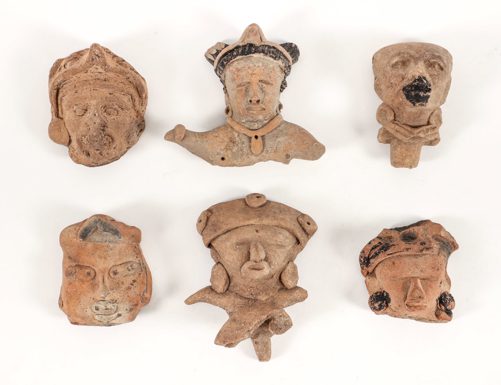 6 Pre-Aztec Effigy Heads from the Tlaxcala and Puebla Region: Pre-Aztec (before 13th century) from the Tlaxcala and Puebla area of central Mexico, assortment of Heads, some wearing ritual headwear and jewelry, several with glazed decoration, largest H:4.5 inches