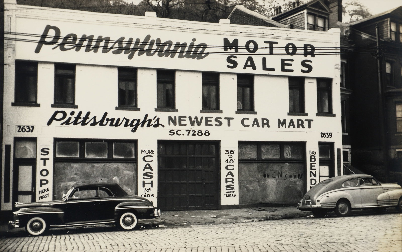 Teenie Harris vintage photo Pennsylvania Motor Sales, Pittsburgh's Newest Car Mart: Harris, Charles (Teenie) (American/Pittsburgh, 1908-1998), Pennsylvania Motor Sales, Pittsburgh's Newest Car Mart, vintage gelatin silver print, 7 x 10.75 inches, framed measuring 12 x 16 inches.