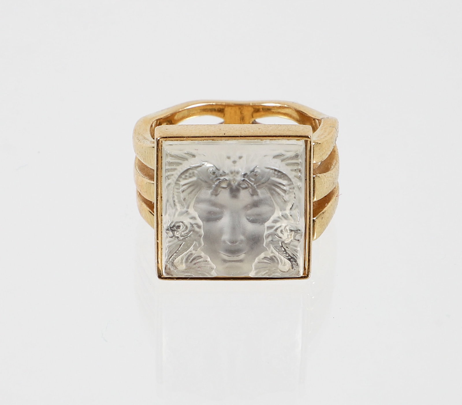 Lalique Arethuse Portrait Ring: Lalique Arethuse carved clear glass portrait ring. The square crystal is set in a gold vermeil mounting with 3 bands of curvy cutwork. Measures 15.6 mm in width. Size 6 1/4. Marked "Lalique".