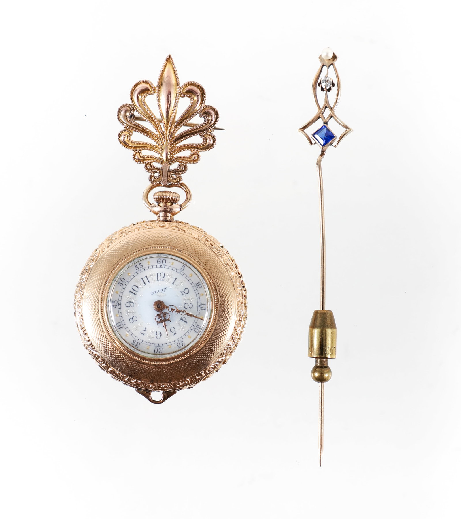 Ladies Antique Jewelry: Ladies antique jewelry. Includes a Ladies Elgin gold filled pocket watch, with abstract fleur de lis clip/pin. The cutwork Feather shaped pin measures 1" in length, 3/4" wide, and is marked "PSCO". Th