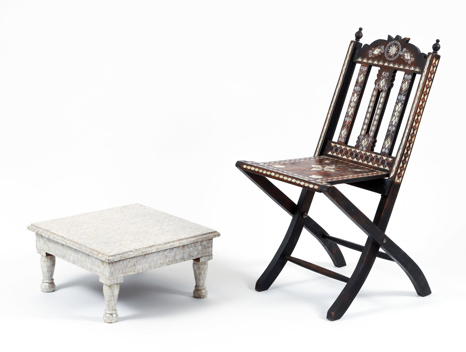 Moorish Style Mother of Pearl Inlay Chair and Ottoman: 20th century Moorish style folding campaign chair together with a mother of pearl inlaid ottoman. Chair with mother of pearl inlay at seat and back, along with inset metal scrolling. Ottoman entirely 