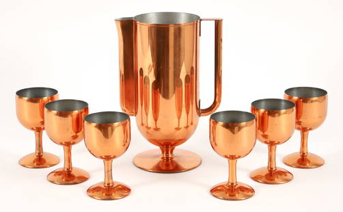 Norman Bel Geddes for Revere Copper Barware Set Baron: Norman Bel Geddes for Revere Art Deco Baron copper plated barware set, 1930s. No. 7631 in the catalog. Tall pitcher on a stem base with fluted spout and tubular handle. 6 stemmed goblets. Apparently u