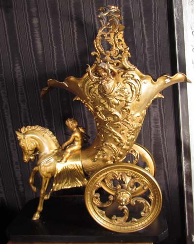 Fine Continental Patinated and Gilt Bronze Chariot: Title: Fine Continental Patinated and Gilt Bronze Chariot Centerpiece in the Rococo style, the horse-drawn cornucopia chariot ornamented with Cupids and delicately rendered foliate scrollwork, on a bl