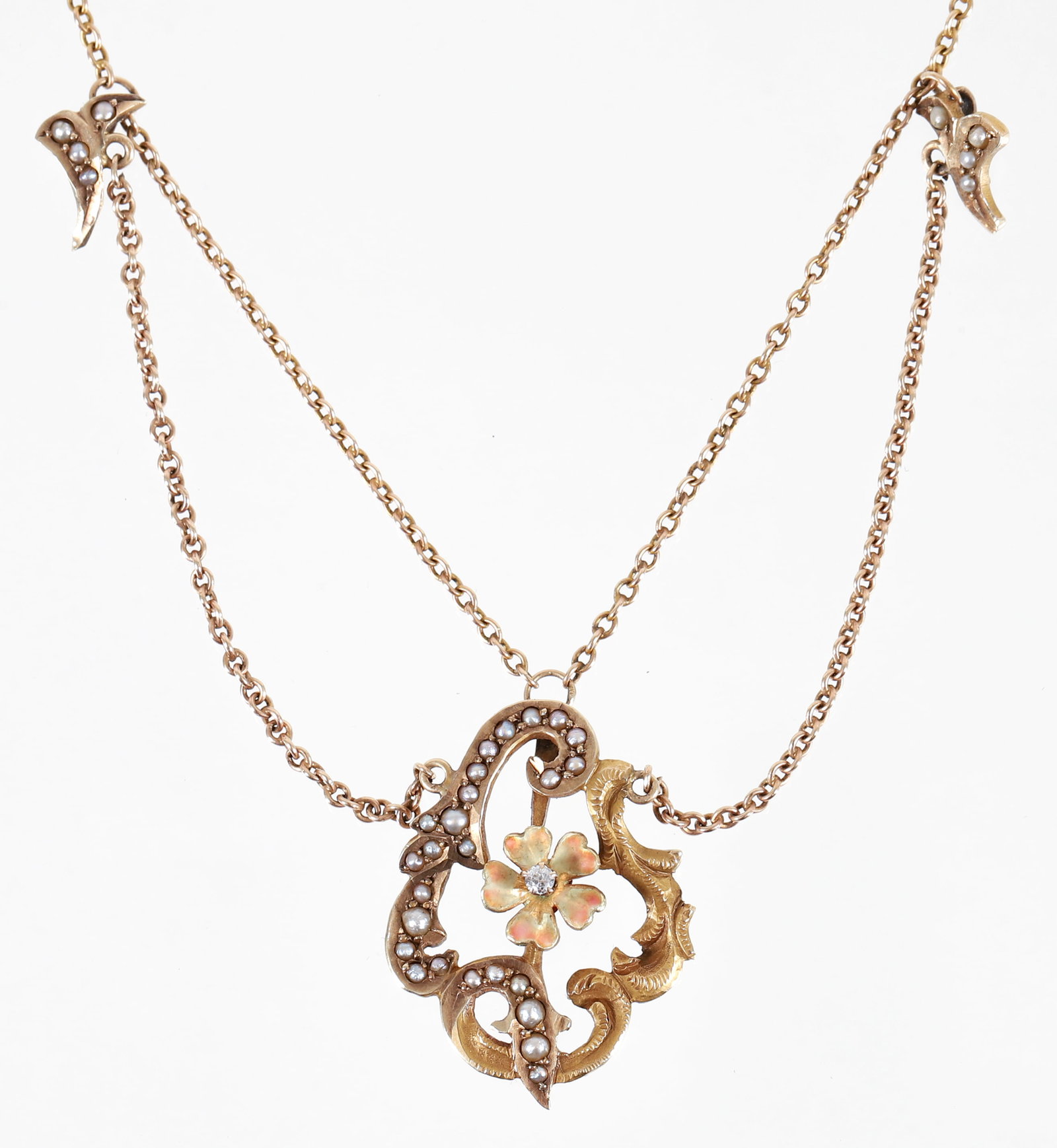 10K Art Nouveau Convertible Pendant Necklace: 10K yellow gold Art Nouveau convertible pendant necklace. The organic cutwork pendant is fashioned of curling vines, adorned on one side with prong set pearls and the other is decorated in detailed en