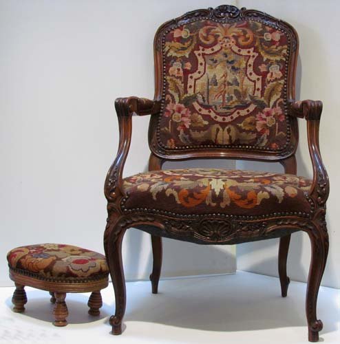 French Style Needlepoint Chair and Footstool: Title: French Style Needlepoint Chair and Footstool with carved back and skirt Medium: wood Dimensions: 38 x 27 x 22 inches