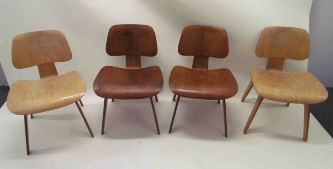 4 Eames DCW Chairs 2 in Ash and 2 in walnut plywoo: Artist: Eames, Charles and Ray Title: 4 DCW plywood Chairs Medium: ash and walnut wood Dimensions: 28.75 x 19.5 x 20.5 inches Signature: unmarked