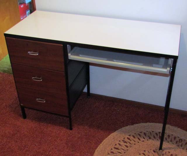 Nelson Herman Miller Steelframe Desk: Artist: Nelson, George for Herman Miller Title: Steelframe Desk with polished chrome pulls, laminate top, walnut sides and drawer fronts Date: c. 1950s Medium: walnut with laminate top Dimensions: 29 