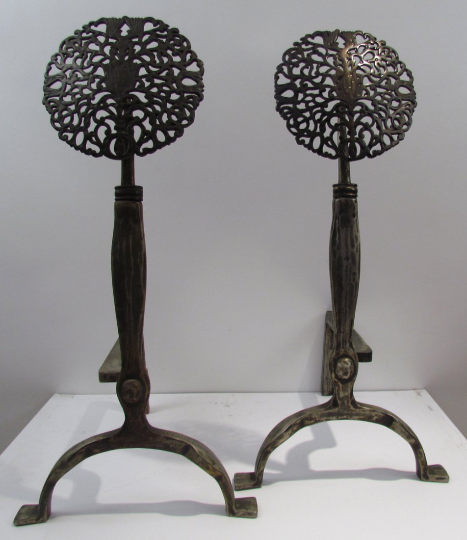 Pair of brass and iron Arts & Crafts andirons with: Title: Pair of brass and iron Arts & Crafts andirons with reticulated medallion top Medium: forged iron Dimensions: 27.5 x 13.25 x 15.75 inches Provenance: The Estate of Joseph and Edith Trees, Gibson