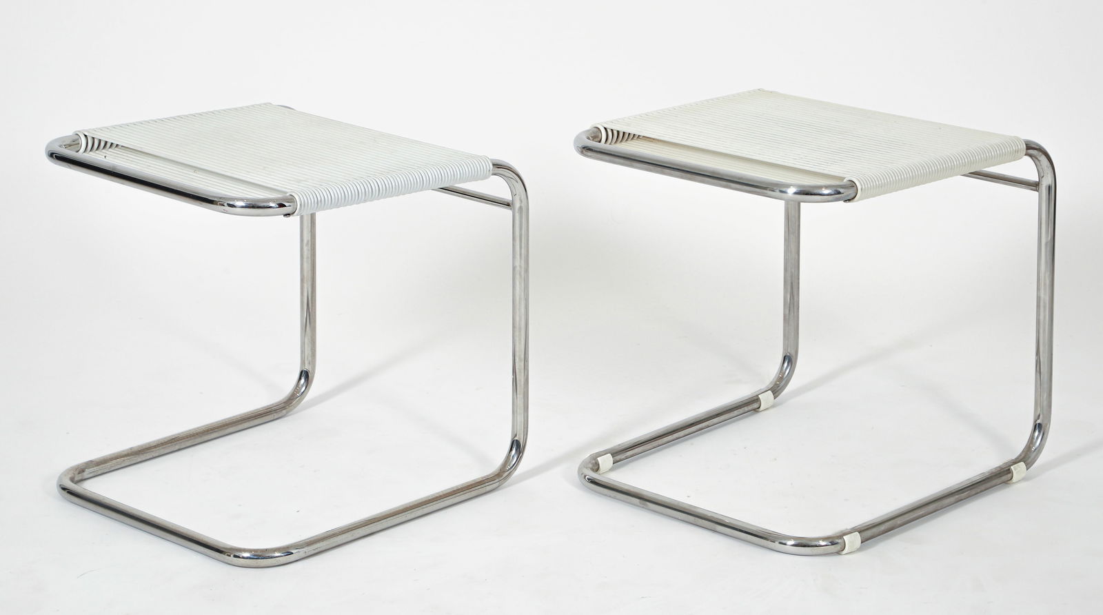 Pair of Andre Dupre for Knoll Ottomans: Pair of Andre Dupre for Knoll ottomans, American, 1960s. Plastic cording over a tubular chromed steel frames. Apparently unlabeled and unmarked. 16.5 x 16 x 16.5 inches.