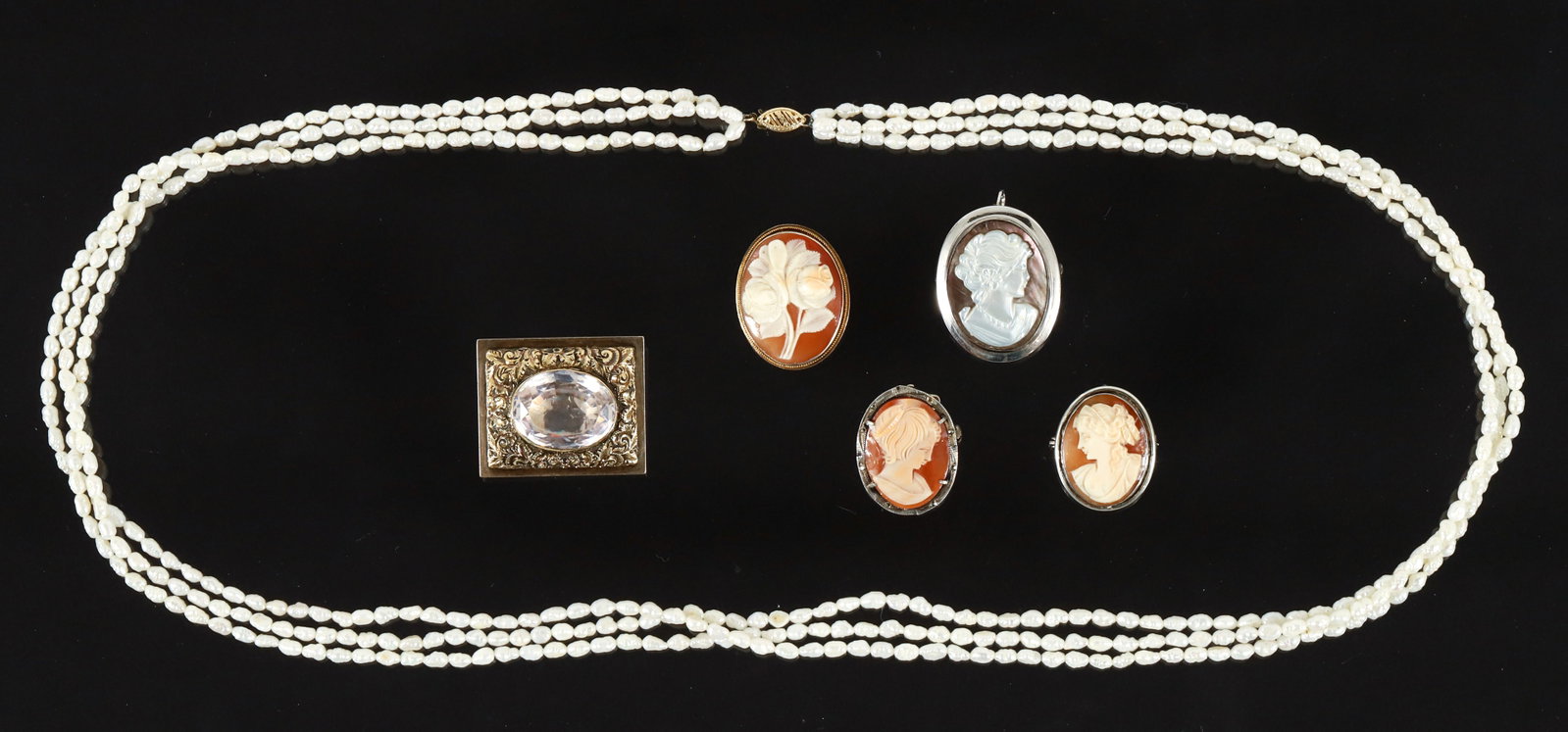 Seed Pearls Necklace with 5 Cameo and Victorian Pins: 3 strand seed pearl necklace with a 14k cutwork pearl closure. Measures 30'' in length, 3/8'' wide laying flat. Marked "14k IWI". Approx. 39.2 grams. 9k rectangular mourning brooch with ornate foliate