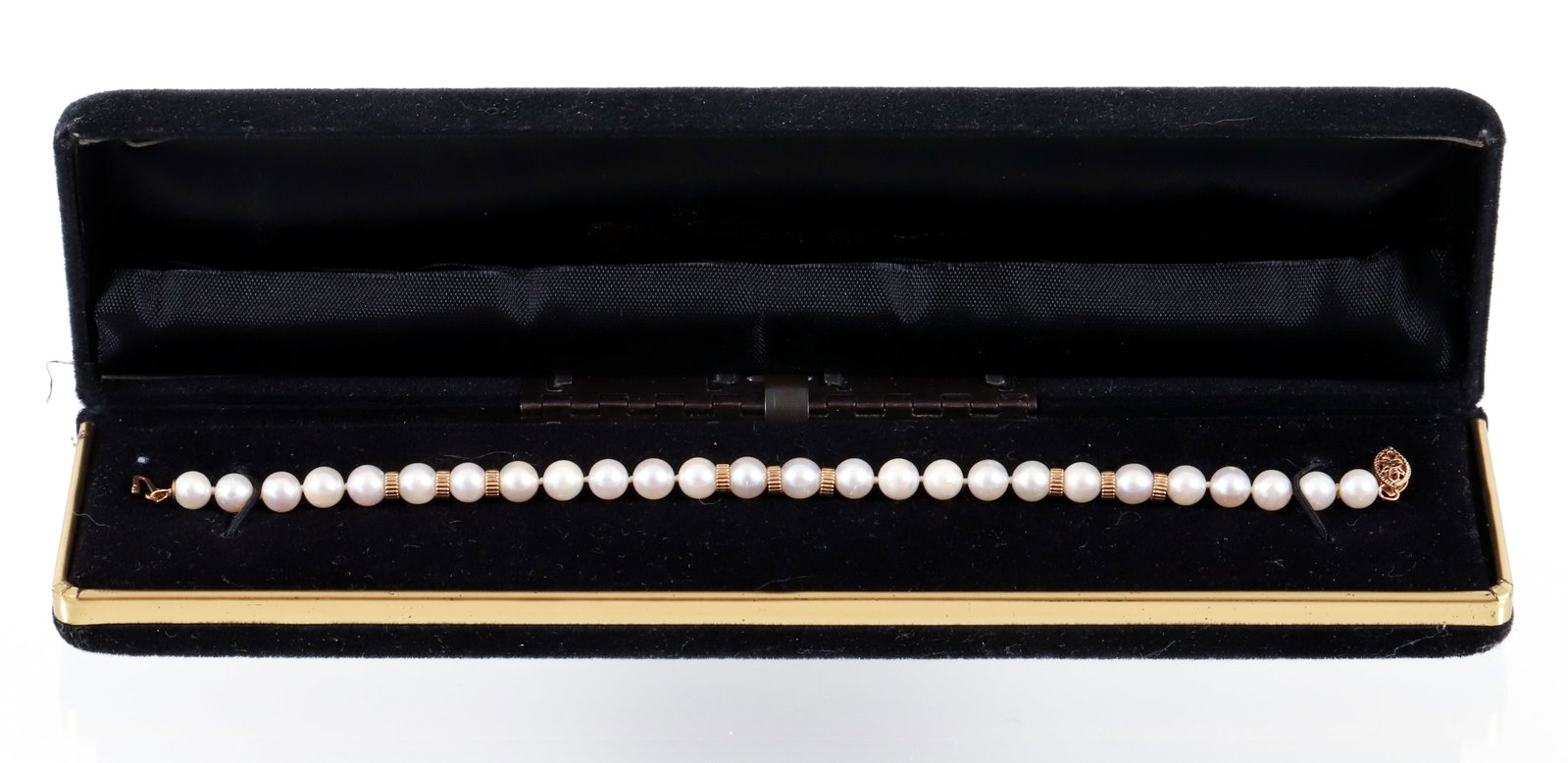 14K Cultured Pearl Bracelet: 14K cultured pearl and gold rondelle bead bracelet. The bracelet is fashioned of 5-6mm cultured pearls and trios of rondelle style yellow gold beads. Measures 7 1/4" in length. Finished with a floral 