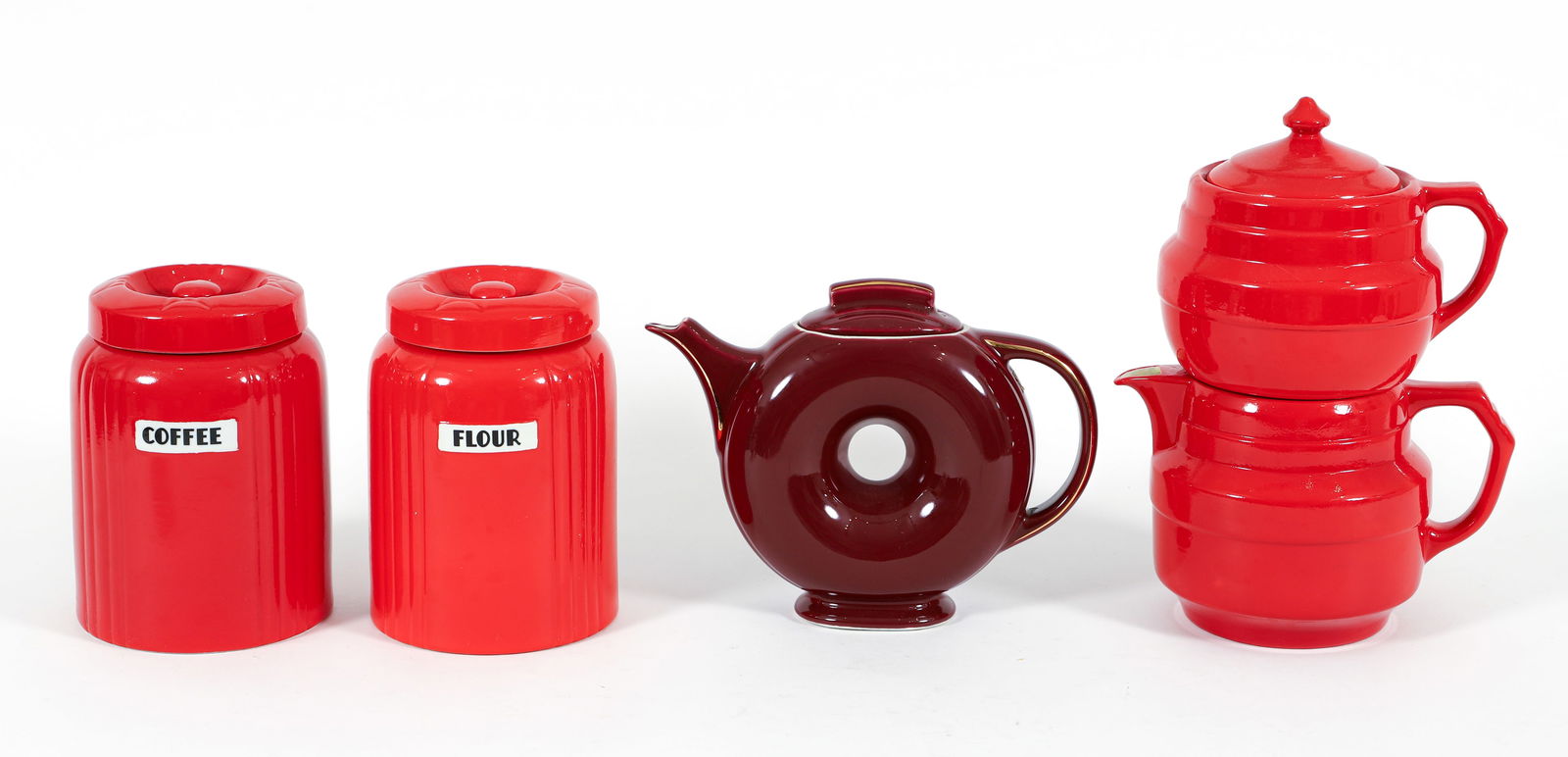 4 Hall China Pc. Inc. Donut Teapot, Cannisters, Drip Coffee: 4 pieces of Hall China Company molded and glazed earthenware kitchenware pieces, American, East Liverpool, Ohio, first designed 1930s. Includes: Donut teapot in maroon glaze with white interior, 7.5 x