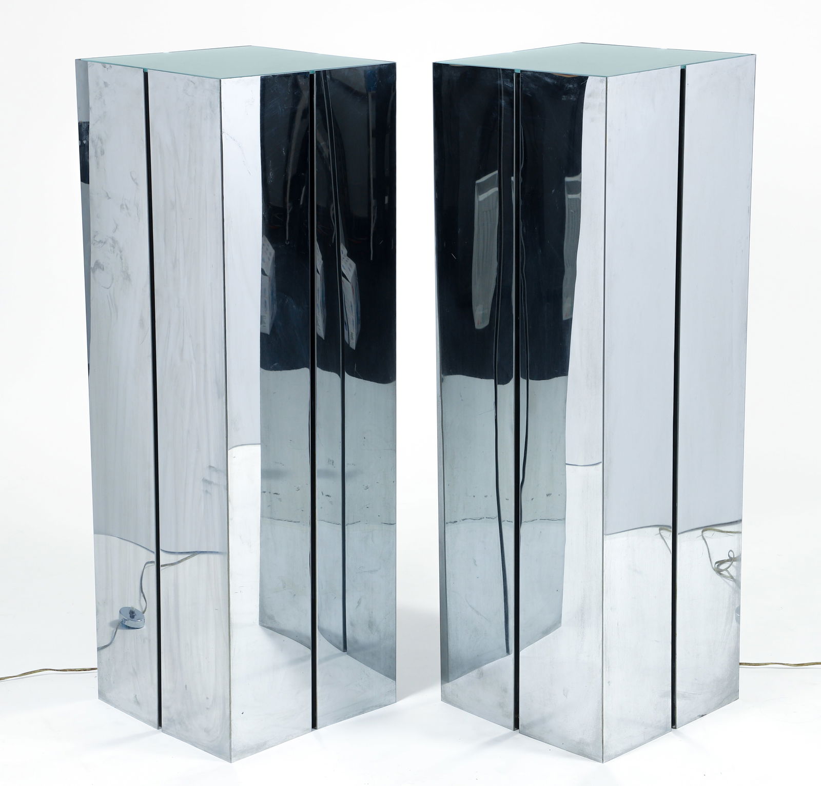 Pair Neal Small for George Kovacs Illuminated Pedestals: Pair of Neal Small for Georges Kovacs tall illuminated pedestals, American, 1970s. Chromed steel panels with recently replaced frosted glass insets resting atop. Each with four socket fixtures on the